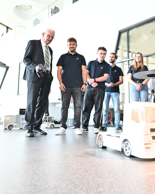 Auszubildende von ZF zeigen Ministerpräsident Kretschmann (links) ein ferngesteuertes, semi-autonomes Truck-Modell. Bildnachweis: ZF Group/ Felix Kästle 