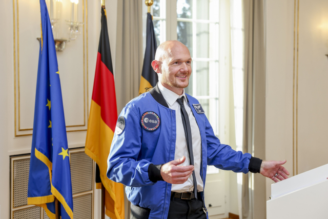 Alexander Gerst in blauer ESA-Jacke spricht vor Rednerpult, im Hintergrund EU-, Deutschland- und Baden-Württemberg-Flagge. © Staatsministerium Baden-Württemberg / Uli Regenscheit

