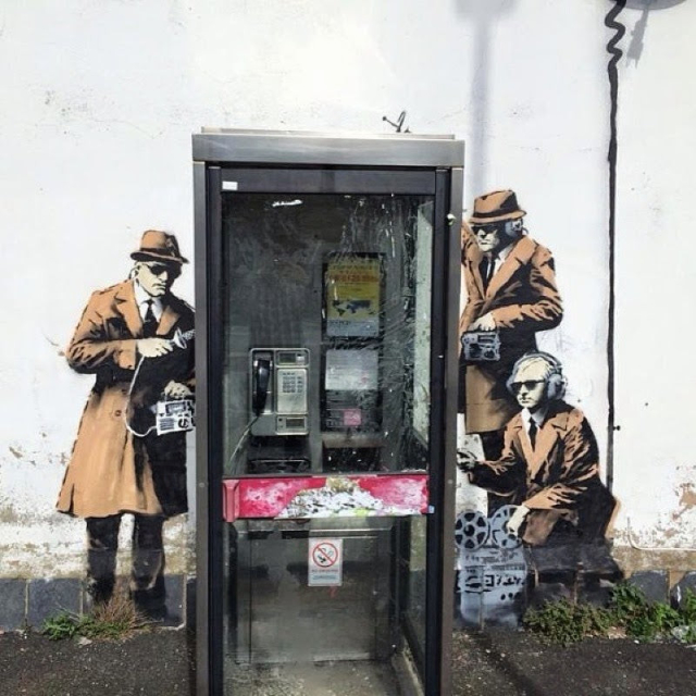 Banksy phone box spies street art
